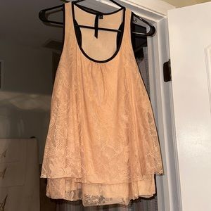 Blush pink lace top with black trim. Size Medium.